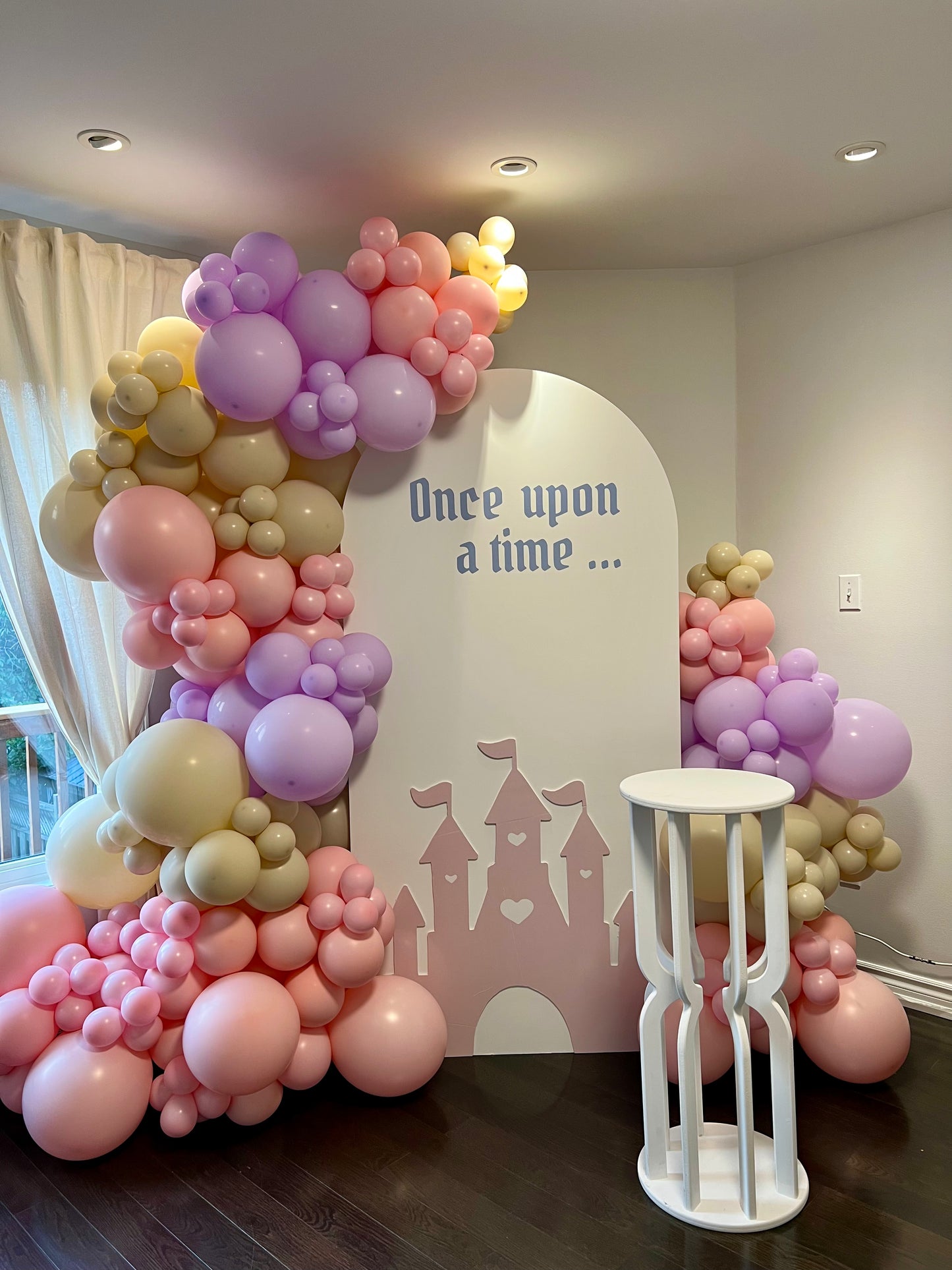 princess themed kids birthday backdrop with castle cutout and balloons