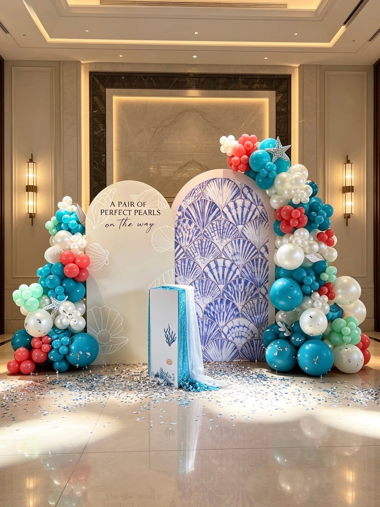 coastal pearl baby shower backdrop with turquoise balloon garlands and shell decor