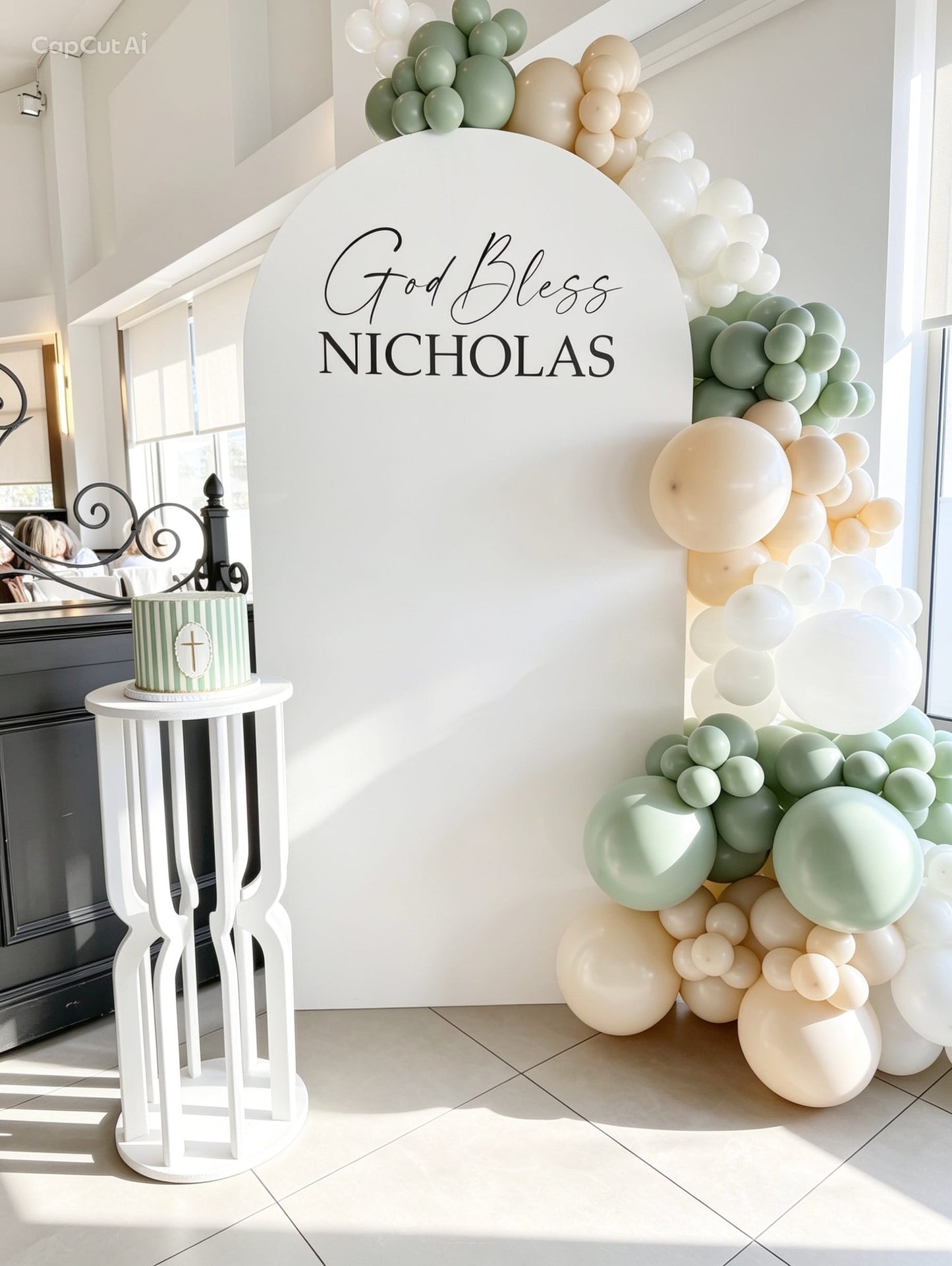 White communion backdrop with sage green, ivory and white balloon garland, custom lettering and white pedestal stand