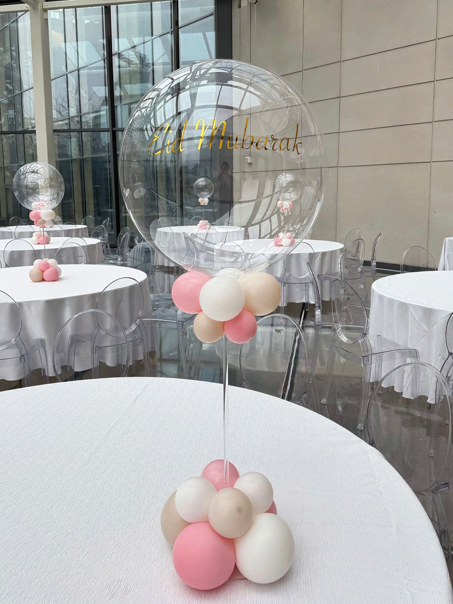 Personalized bubble balloon centerpiece with custom vinyl text and pastel balloon base
