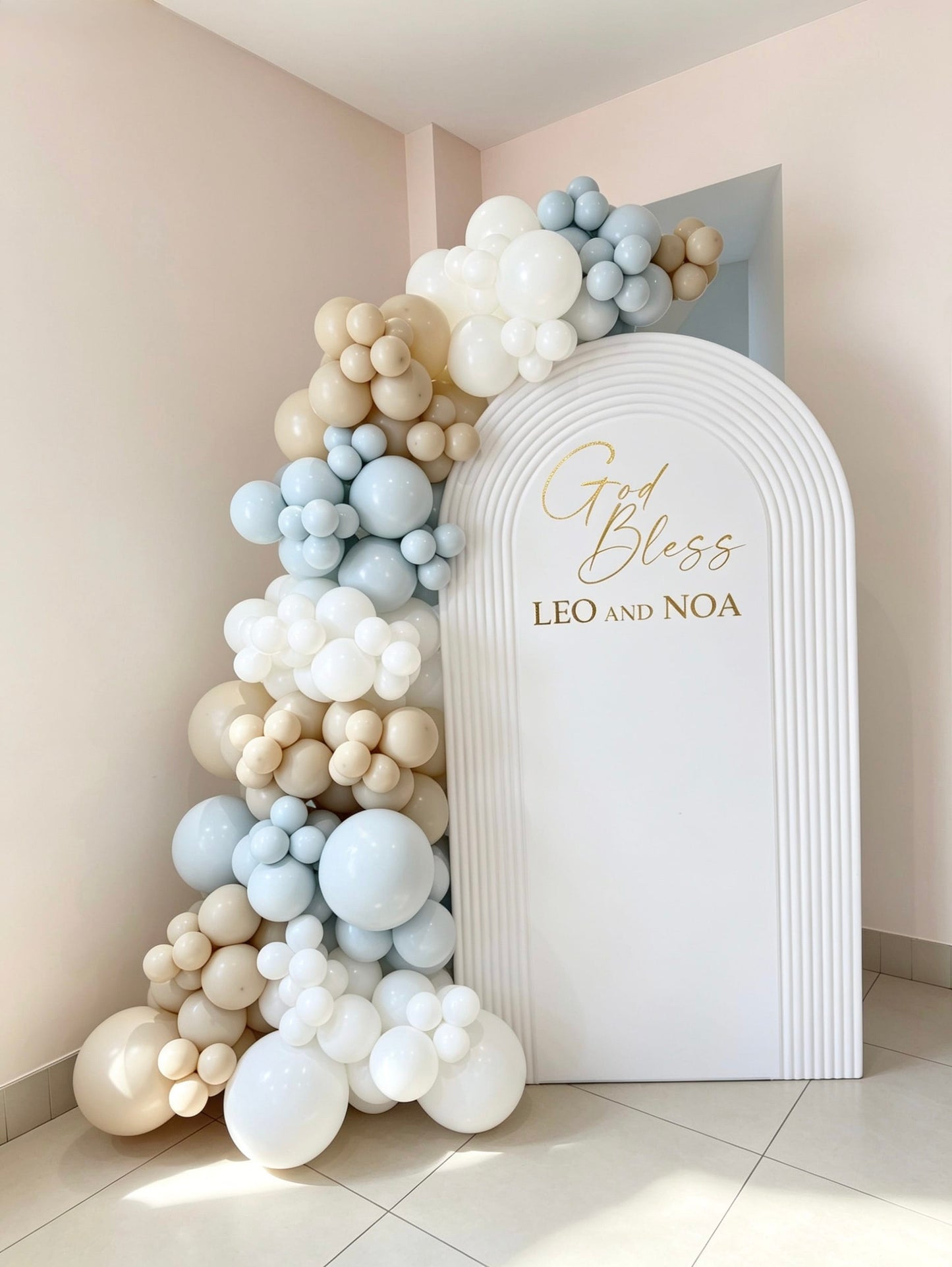 white hollow ripple arch backdrop with blue beige and ivory balloon garland for baptism celebration