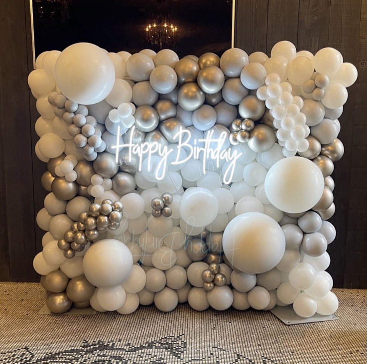 Colorful balloon photo backdrop with various balloon shapes and sizes, creating a festive and vibrant setting for events and photos