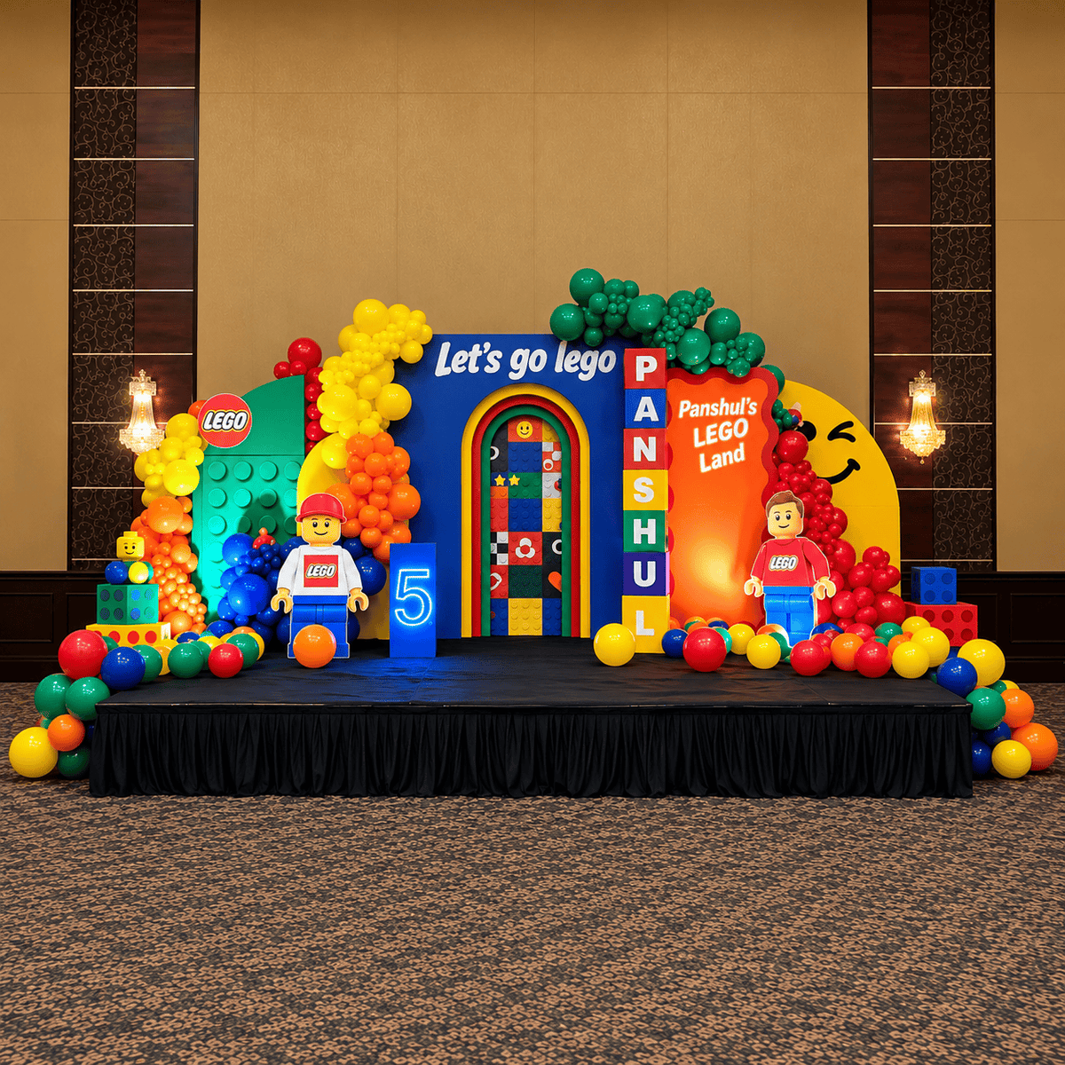 Grand 24 ft LEGO-themed birthday backdrop setup with colourful balloon garlands, custom LEGO Land backdrops, LEGO character cutouts, personalized name blocks and illuminated number 5.