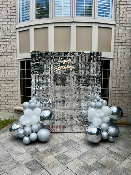  Silver shimmer wall birthday setup with white, silver and chrome balloon garlands