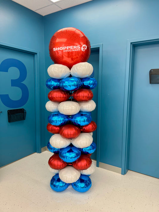 Branded foil balloon column with custom logo topper, created for Shoppers Drug Mart, 8 ft tall corporate balloon display.