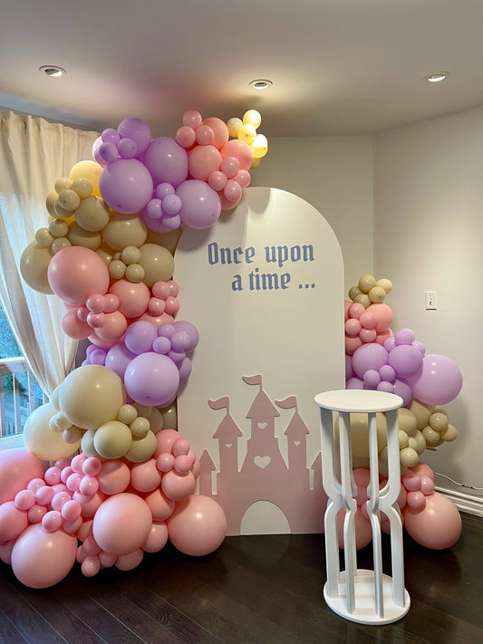 princess themed kids birthday backdrop with castle cutout and balloons
