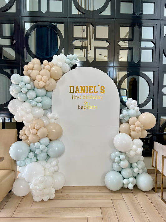 baptism and first birthday balloon backdrop with white beige green garlands