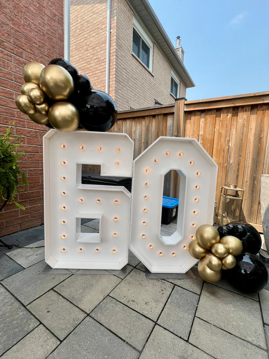 light up marquee numbers with balloon clusters for birthday party
