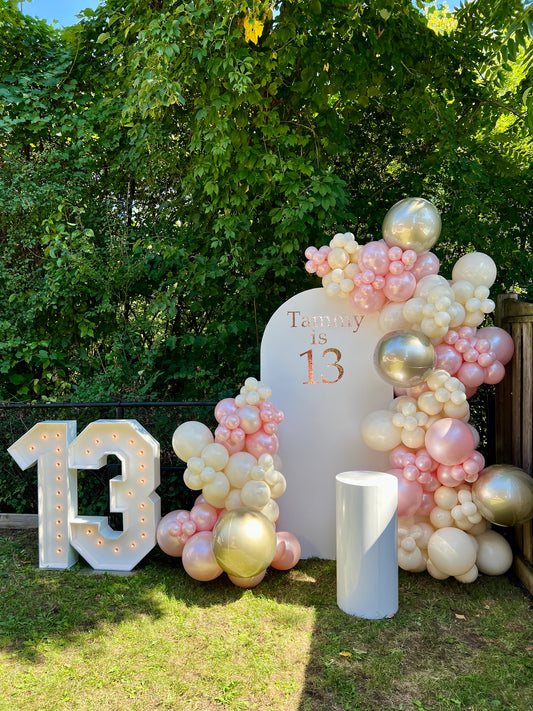blush 13th birthday balloon backdrop with gold pink garland and number
