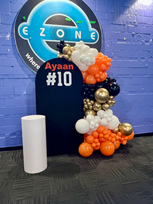 basketball 10th birthday balloon backdrop with black arch and orange balloons