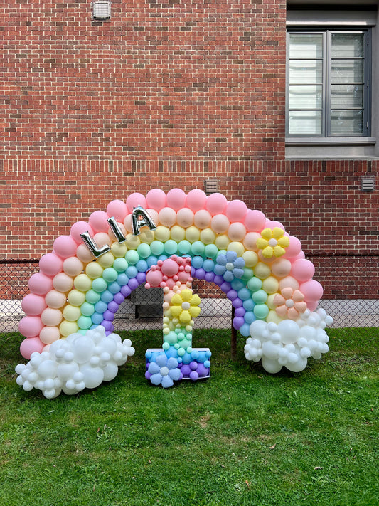 rainbow balloon backdrop with name and mosaic number for kids birthday

