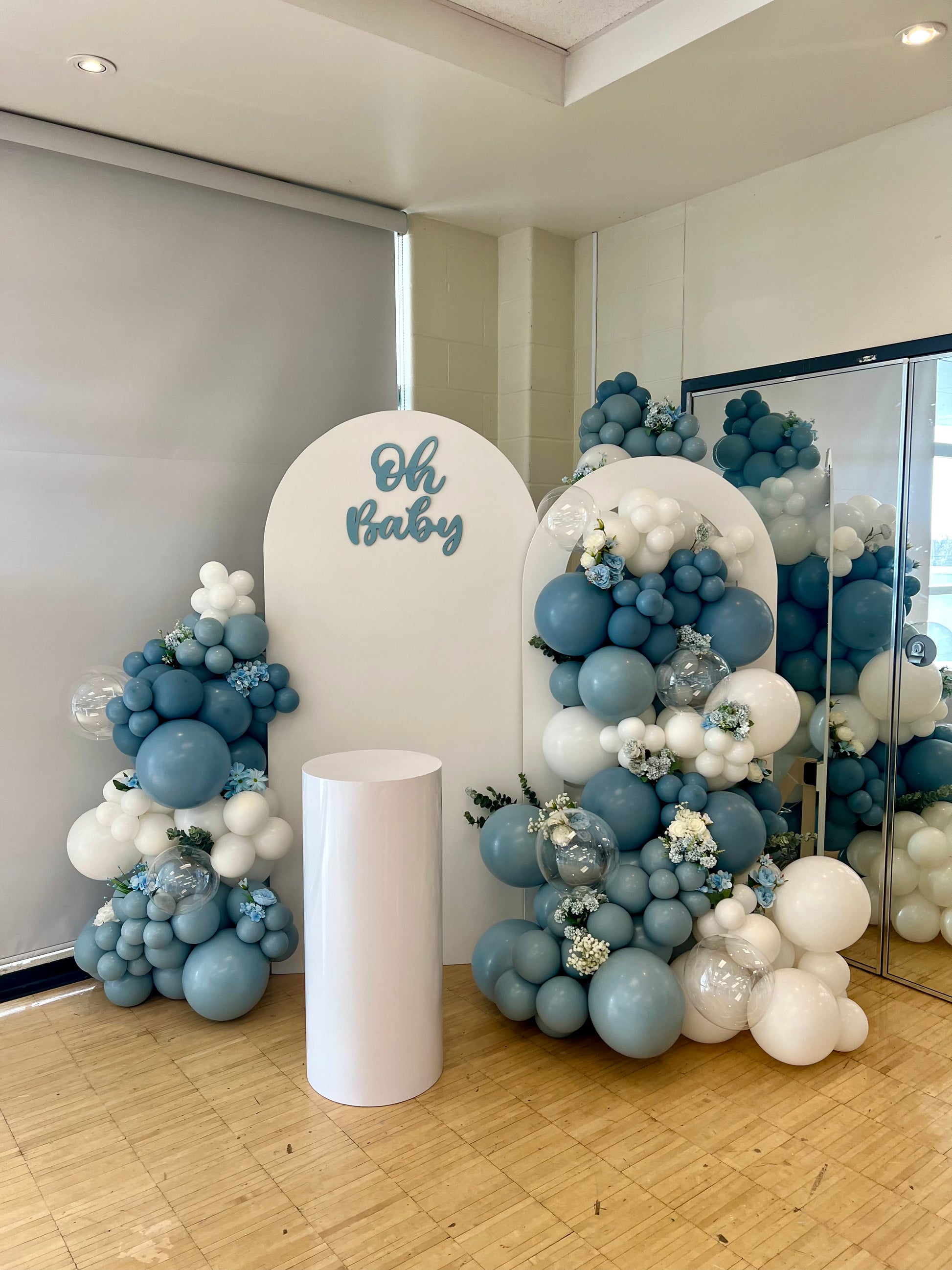 luxury blue baby shower balloon backdrop with arch panels and bubble garlands
