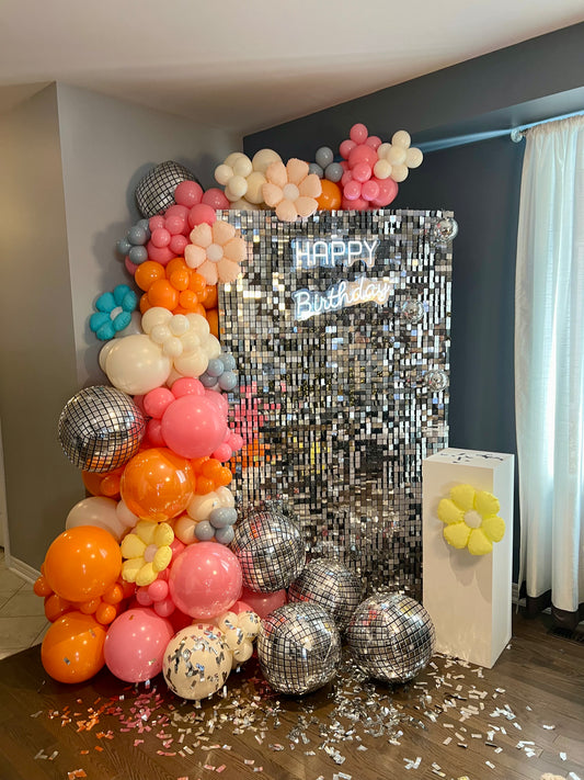 groovy disco birthday backdrop with shimmer wall and retro balloon garland
