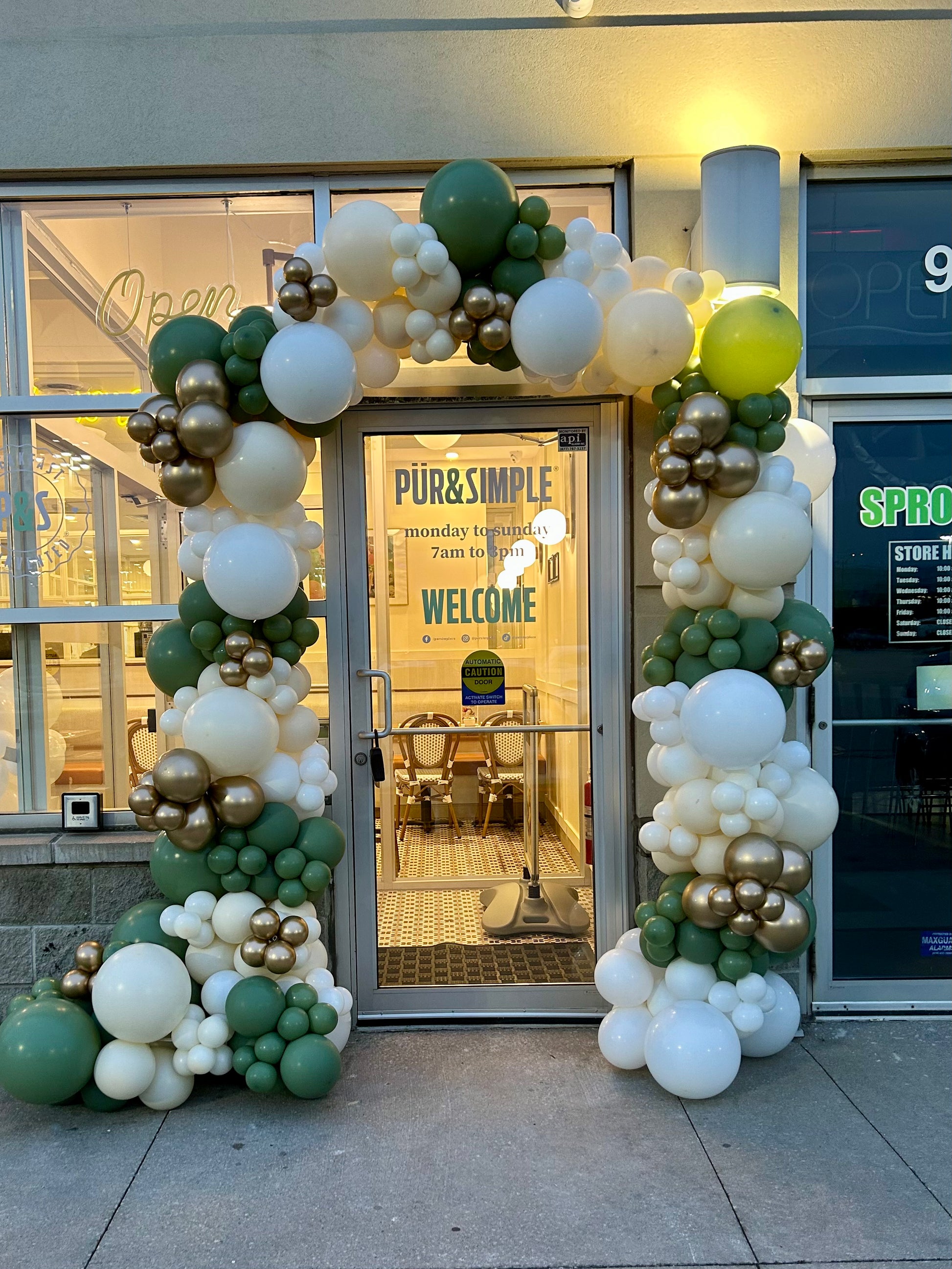 18 ft organic balloon installation around restaurant entrance with custom colours
