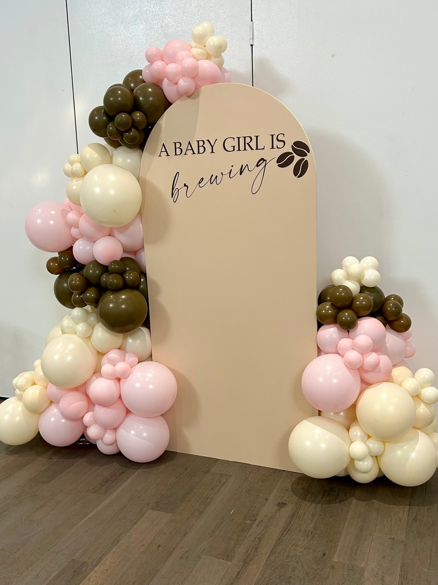 baby girl brewing baby shower balloon backdrop with beige arch and pink brown balloons