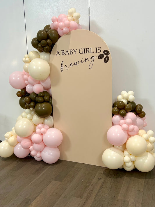 baby girl brewing baby shower balloon backdrop with beige arch and pink brown balloons