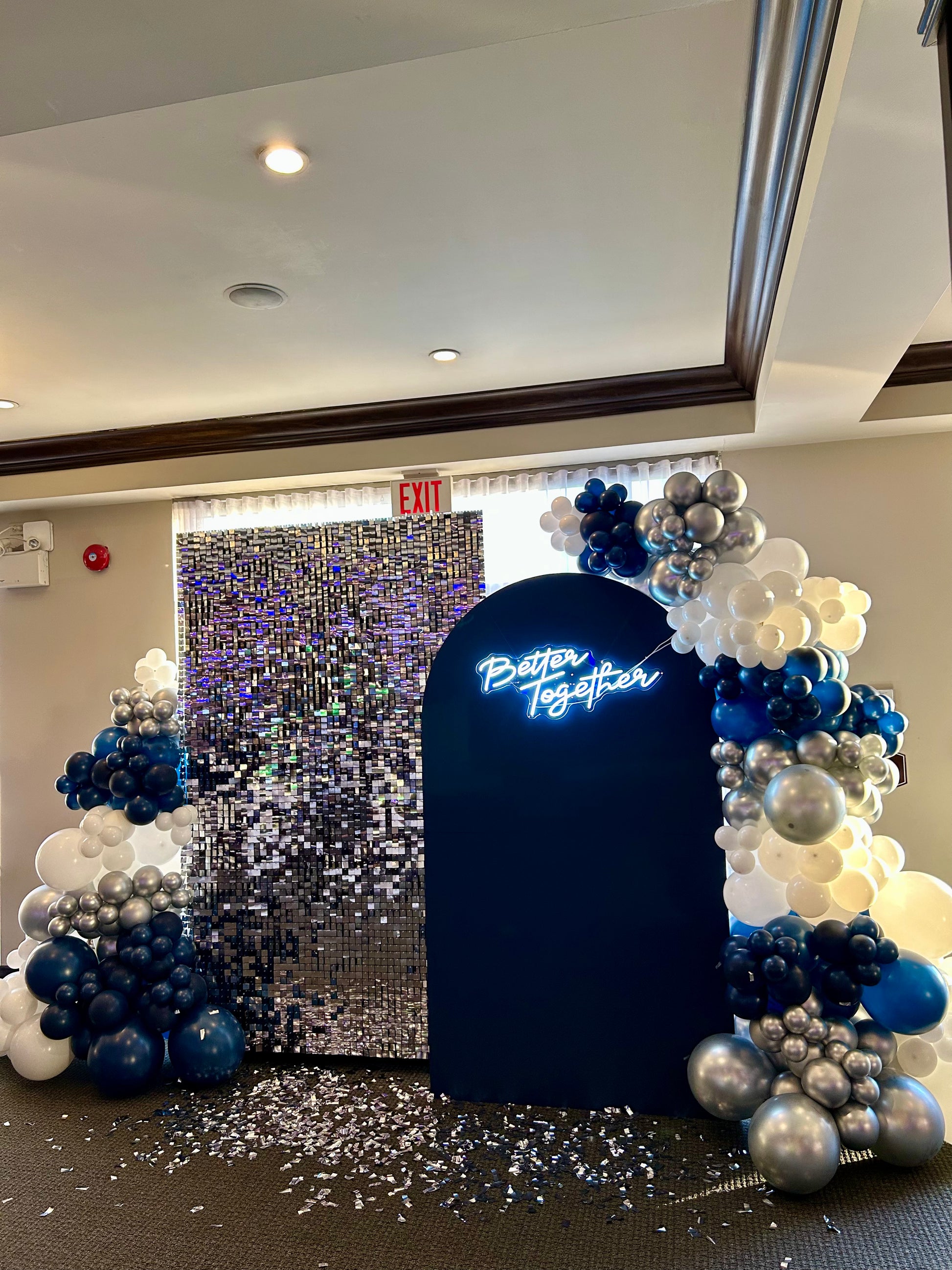 corporate holiday balloon backdrop with shimmer wall and silver garlands
