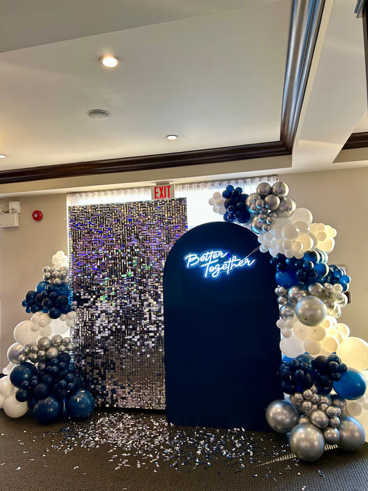 corporate holiday balloon backdrop with shimmer wall and silver garlands
