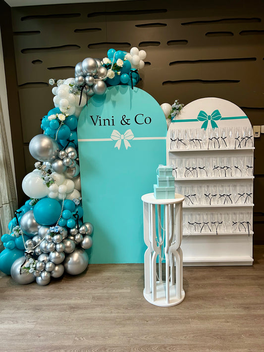 tiffany inspired birthday backdrop with champagne wall and balloon garland
