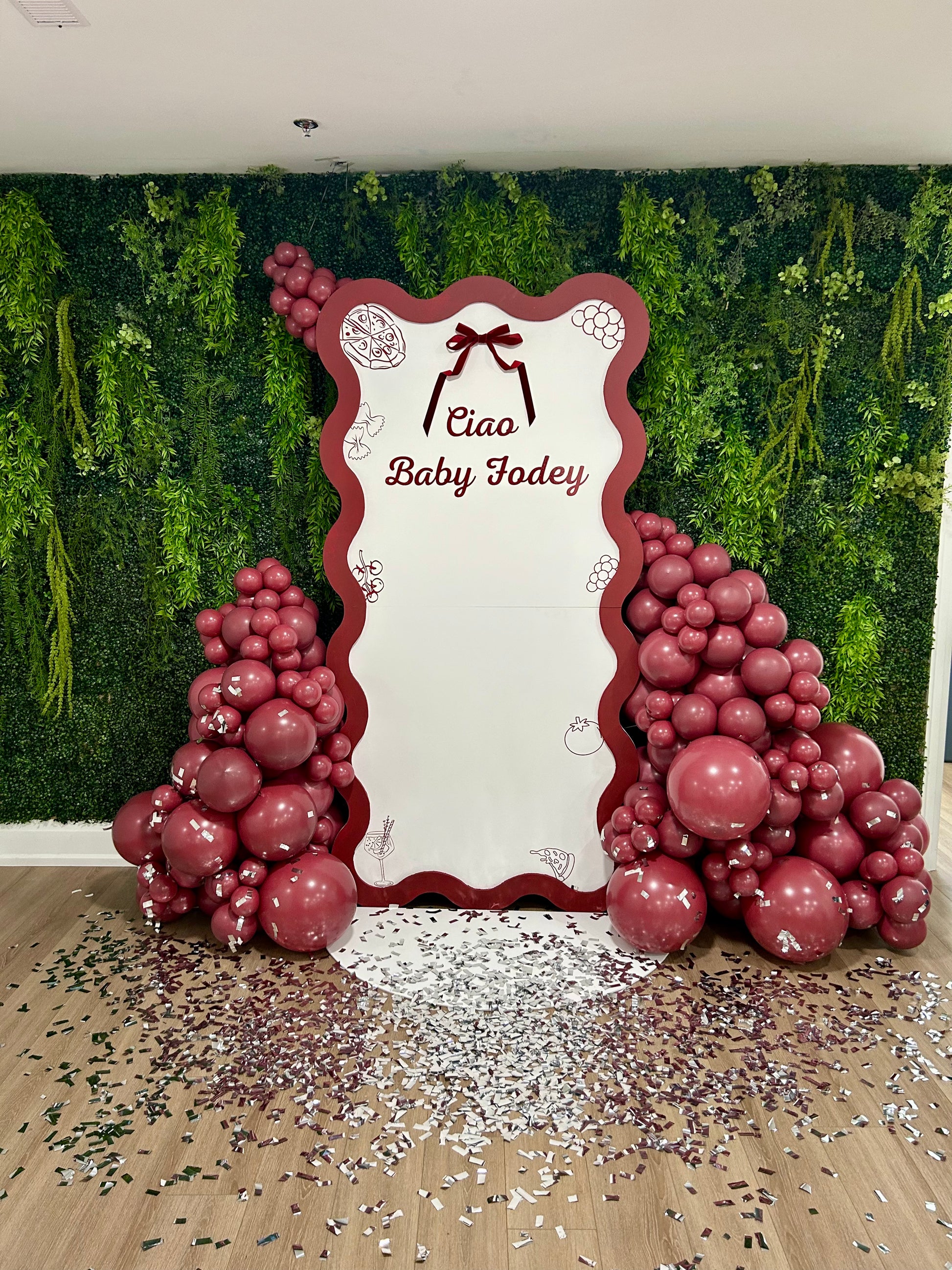 italian inspired bridal shower backdrop with red balloon garlands and bow