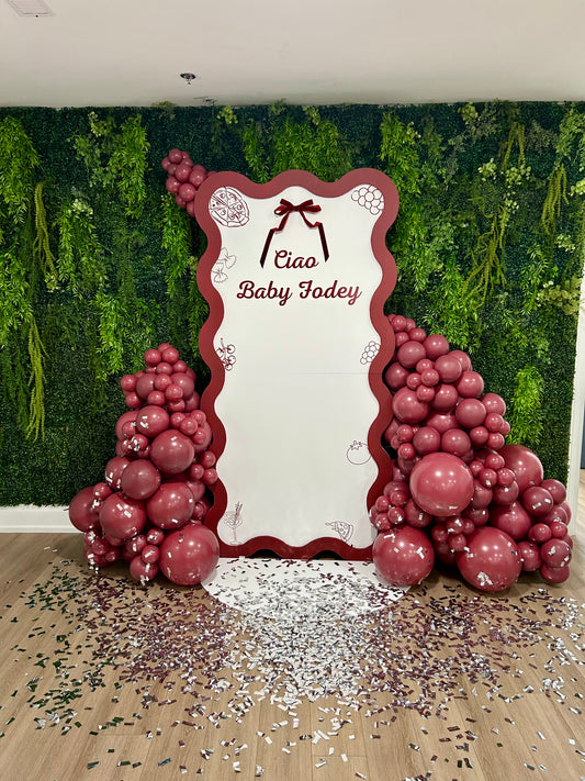 italian inspired bridal shower backdrop with red balloon garlands and bow