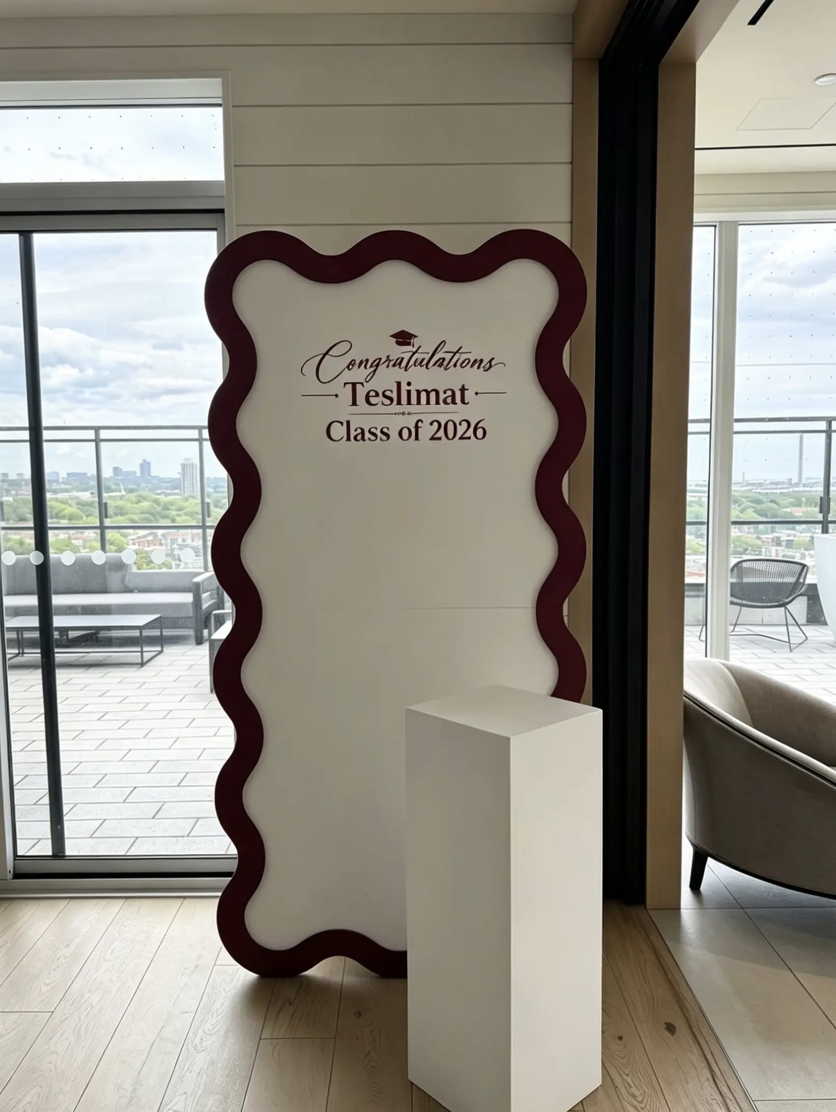 Custom graduation wave backdrop with personalized vinyl lettering for a Class of 2026 celebration.