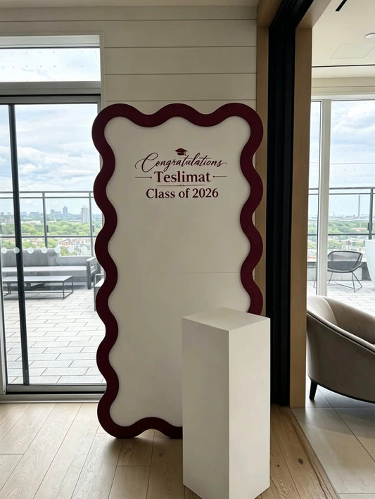 Custom graduation wave backdrop with personalized vinyl lettering for a Class of 2026 celebration.