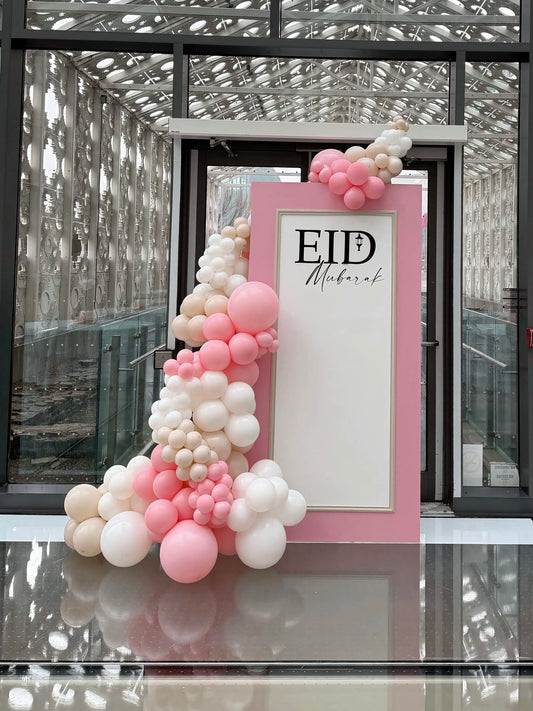 Pink Eid Mubarak backdrop with organic balloon garland in blush, ivory and white colours