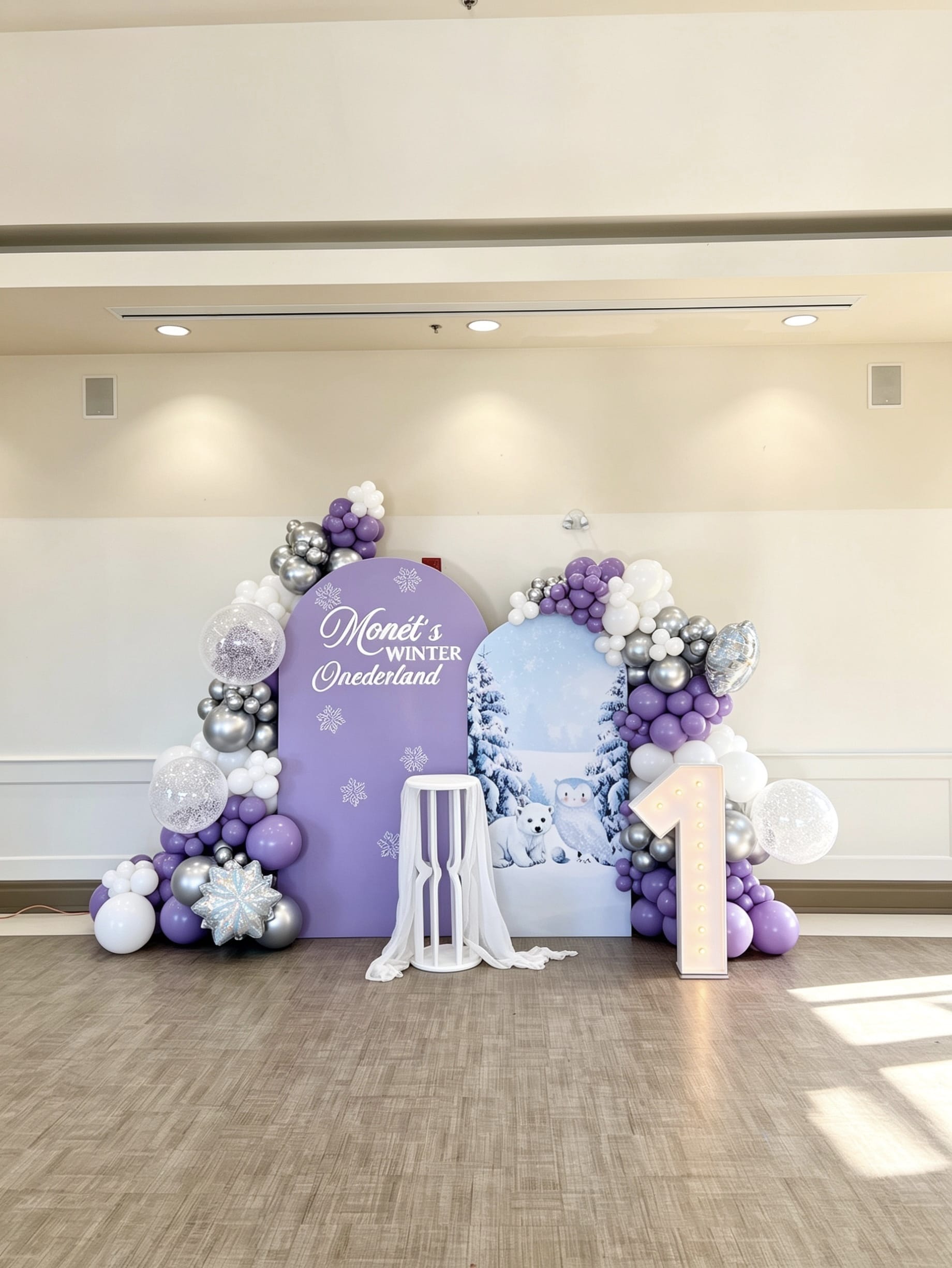 snowy one birthday backdrop with lavender balloon garlands and marquee number