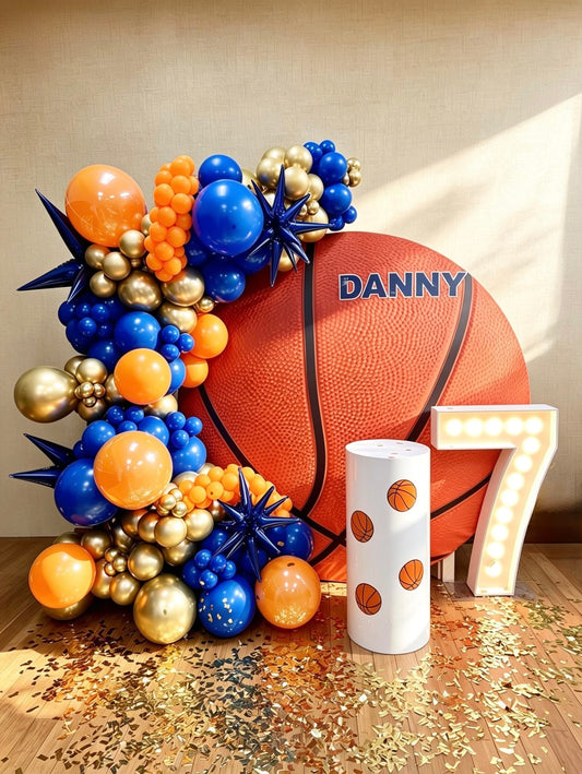 basketball birthday backdrop with blue and orange balloon garland and marquee number