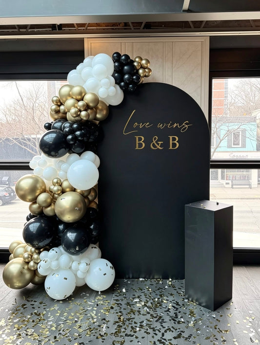 Black bridal shower backdrop with black, white and champagne gold balloon garland