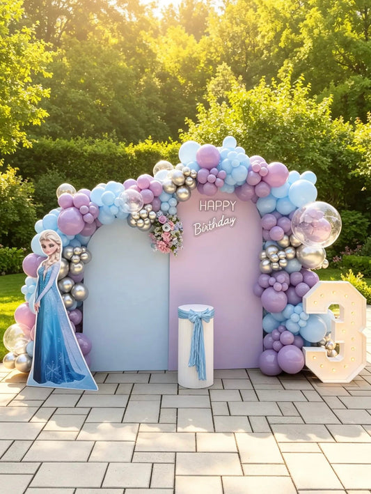 Frozen birthday backdrop with pastel blue, lavender and pink balloon garland, Elsa character cutout, custom birthday sign and light-up marquee number.