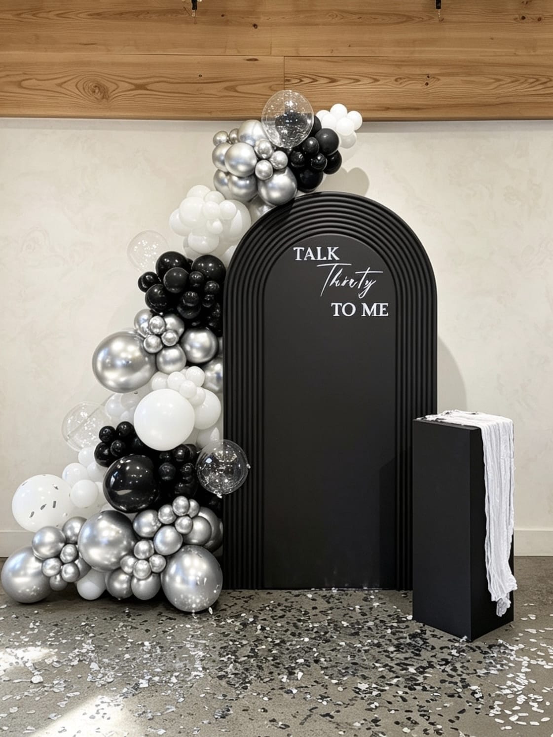 luxury black and silver 30th birthday backdrop with ripple arch and chrome balloons