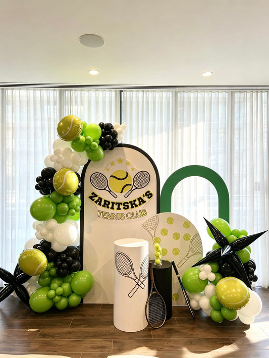 tennis themed birthday backdrop with green balloon garlands and sports decor