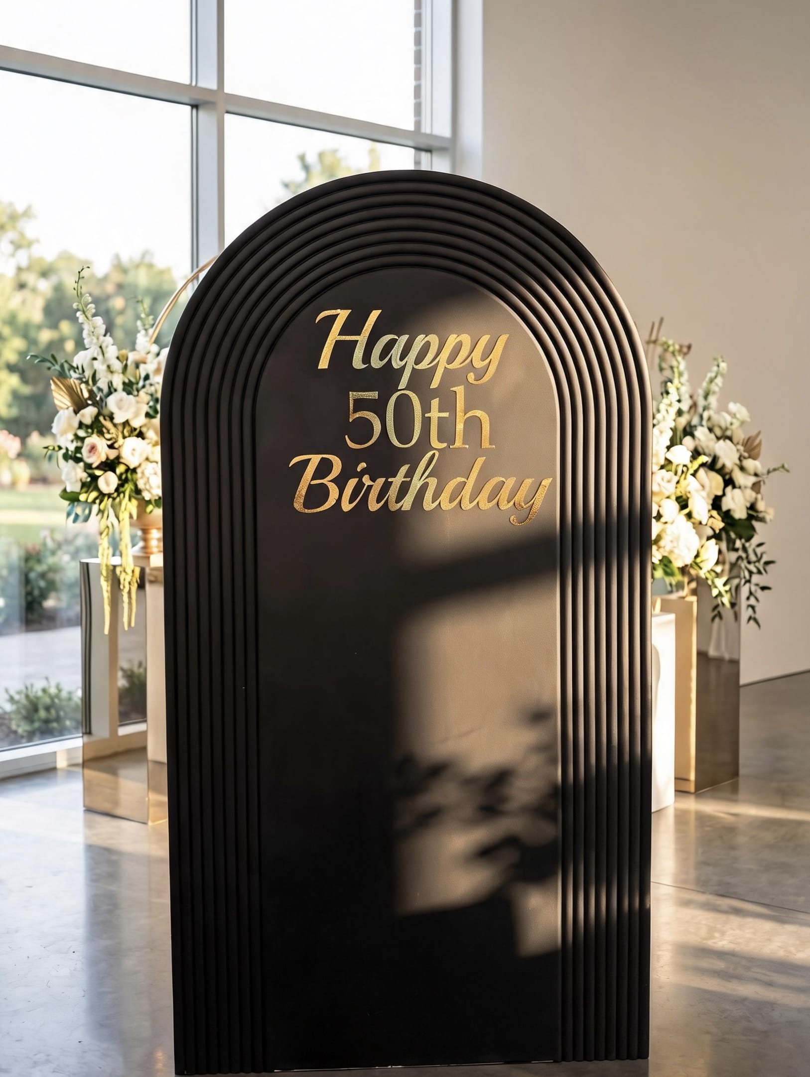 Modern black ribbed arch backdrop with custom gold lettering, available in custom colors and personalized for birthdays, corporate events and special celebrations.