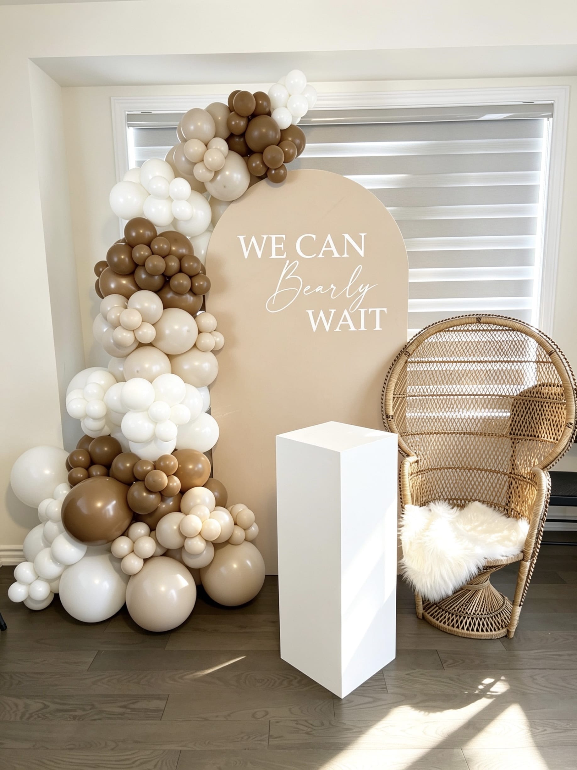 bearly waiting baby shower backdrop with mocha balloon garland and wicker chair