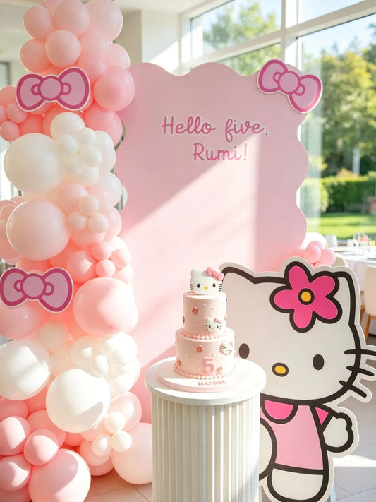 Hello Kitty 5th birthday backdrop with a pink wavy backdrop, blush pink and white balloon garland, Hello Kitty cutout and cake pedestal.