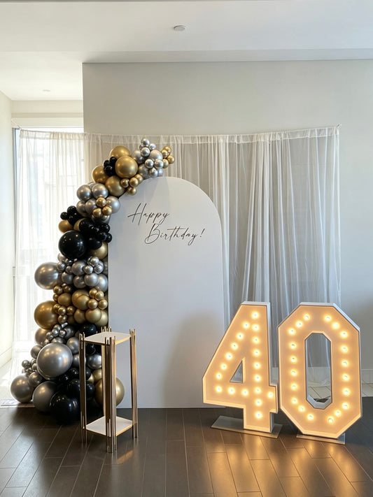 luxury black gold and silver 40th birthday backdrop with marquee numbers and balloon garland