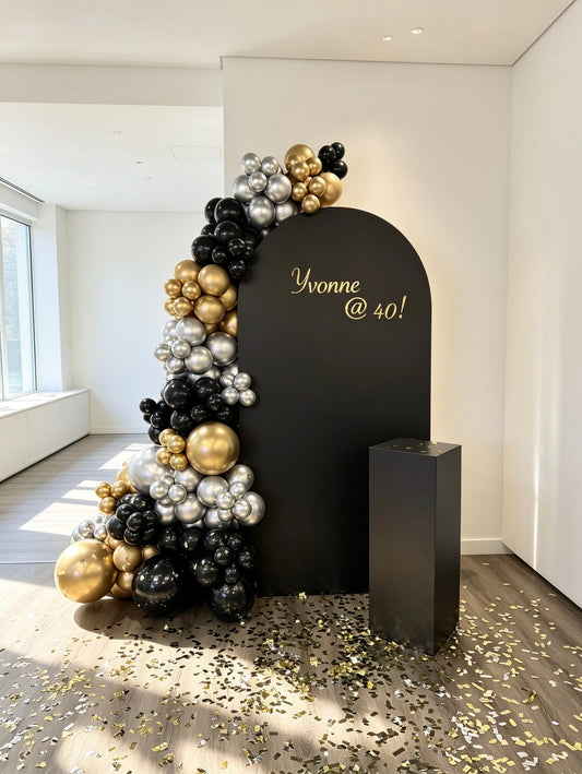 Black birthday backdrop with black, gold and silver balloon garland and custom vinyl text