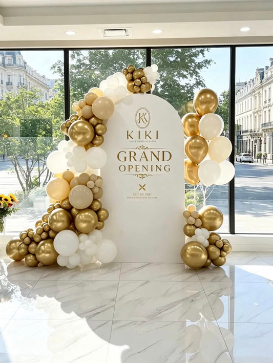 Grand opening backdrop with custom business logo, gold, white and neutral balloon garland and matching helium balloon bouquet.
