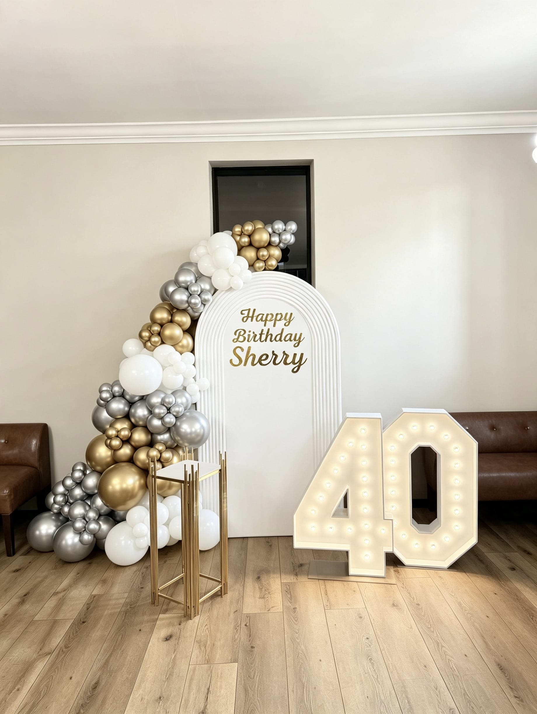 White ripple arch birthday backdrop with white gold and silver balloon garland and marquee 40 numbers