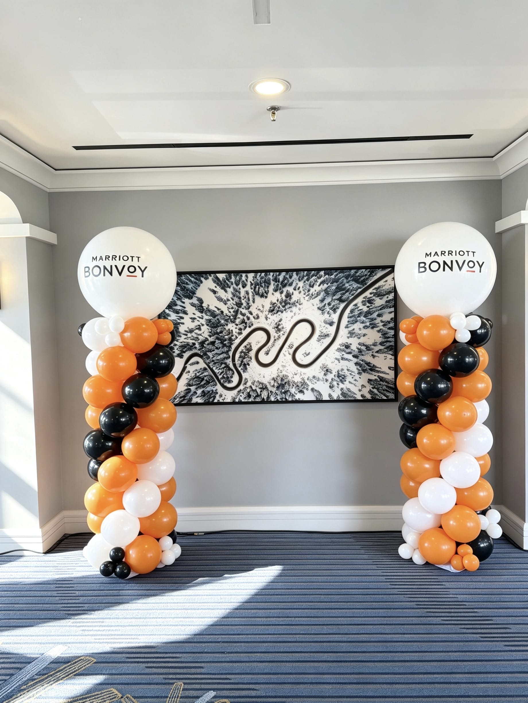 corporate balloon columns with branded jumbo balloons in orange black and white colours