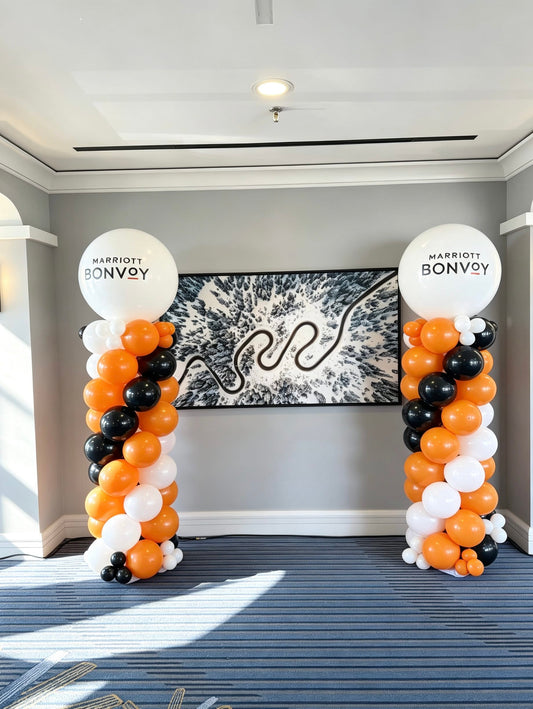 corporate balloon columns with branded jumbo balloons in orange black and white colours