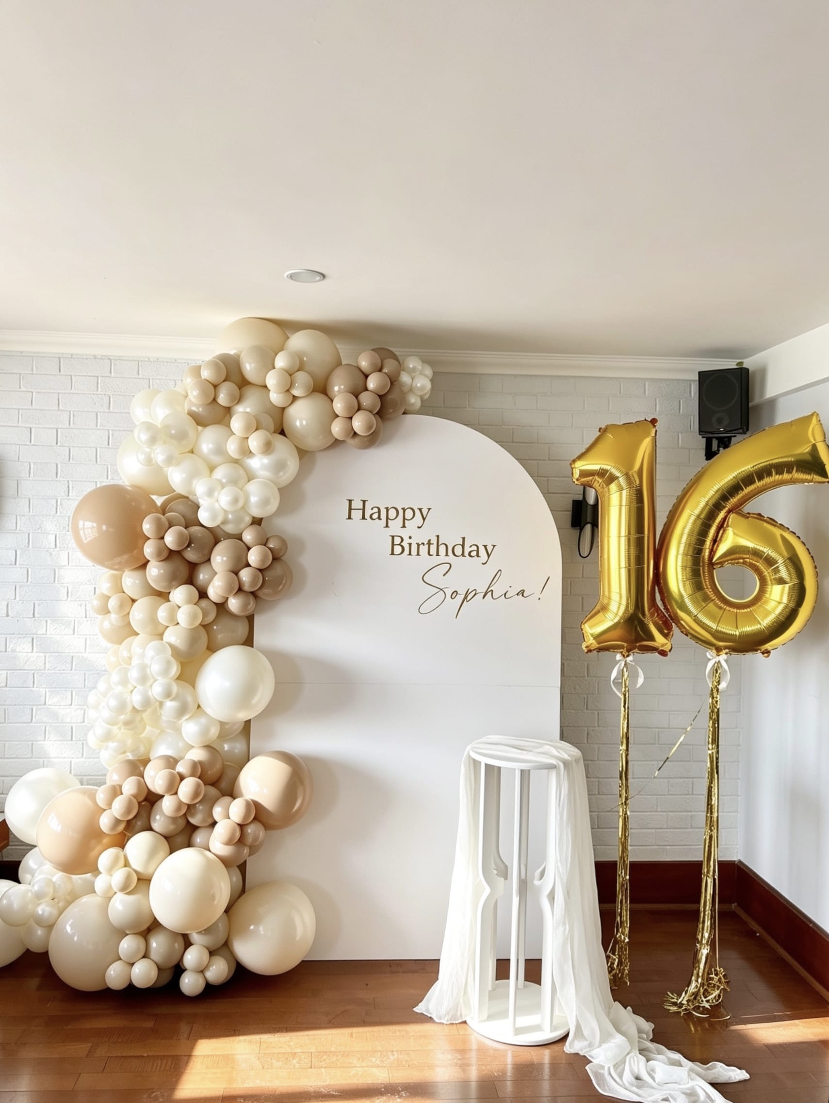neutral sweet 16 balloon backdrop with pearl garland and floating number balloons