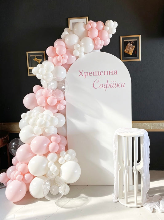 blessed blush celebration backdrop with pink and white balloon garland