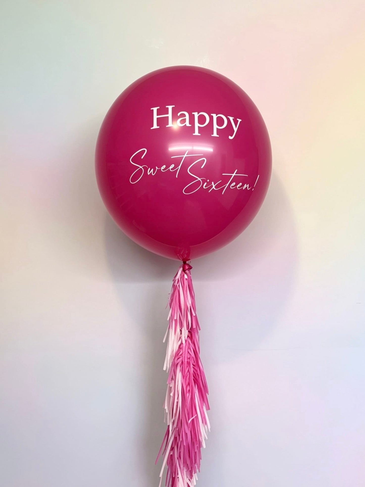 pink 3 ft jumbo balloon with sweet sixteen custom lettering and tassel tail