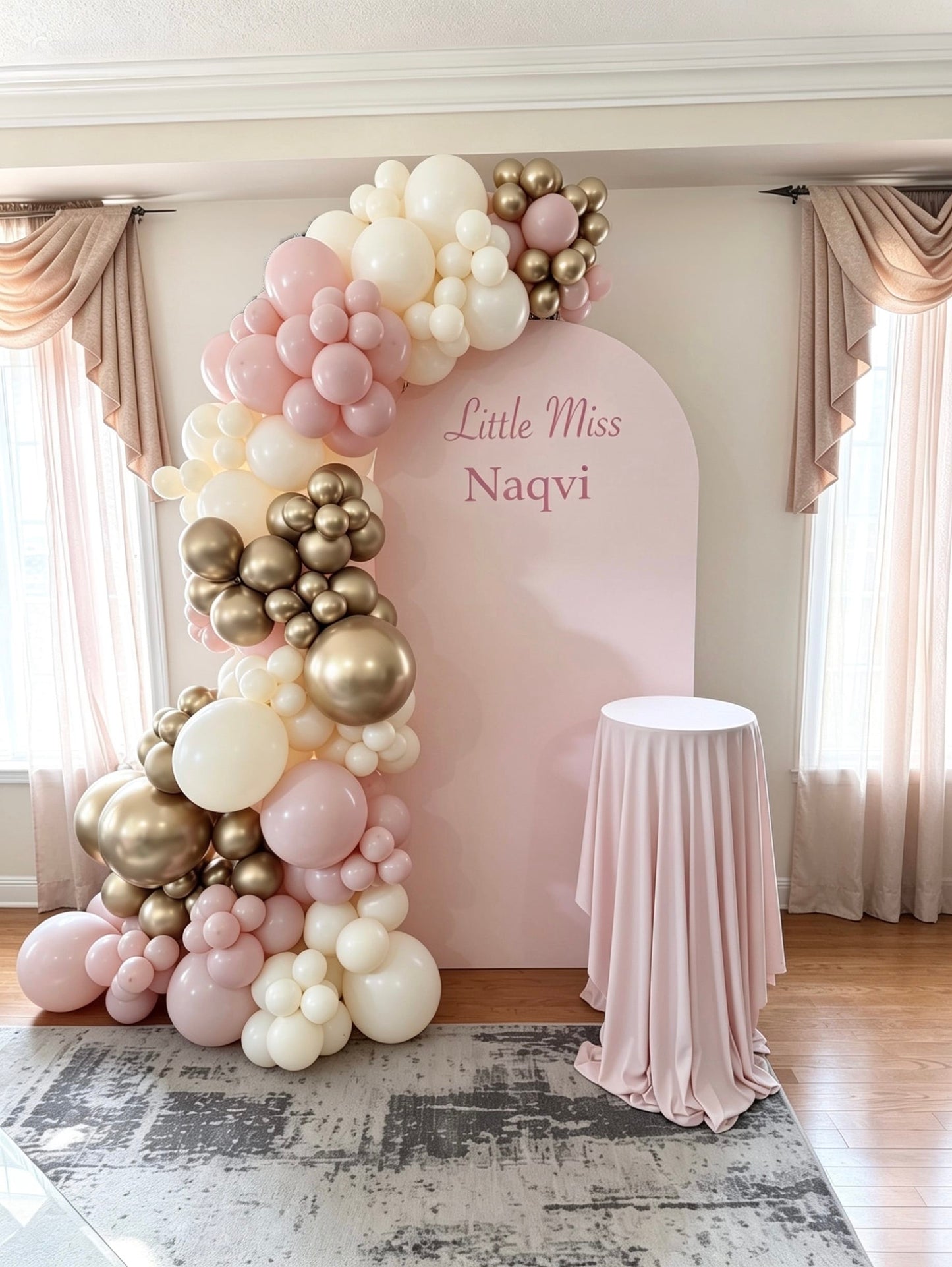 pink full arch backdrop with champagne and blush organic balloon garland