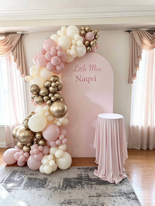 pink full arch backdrop with champagne and blush organic balloon garland