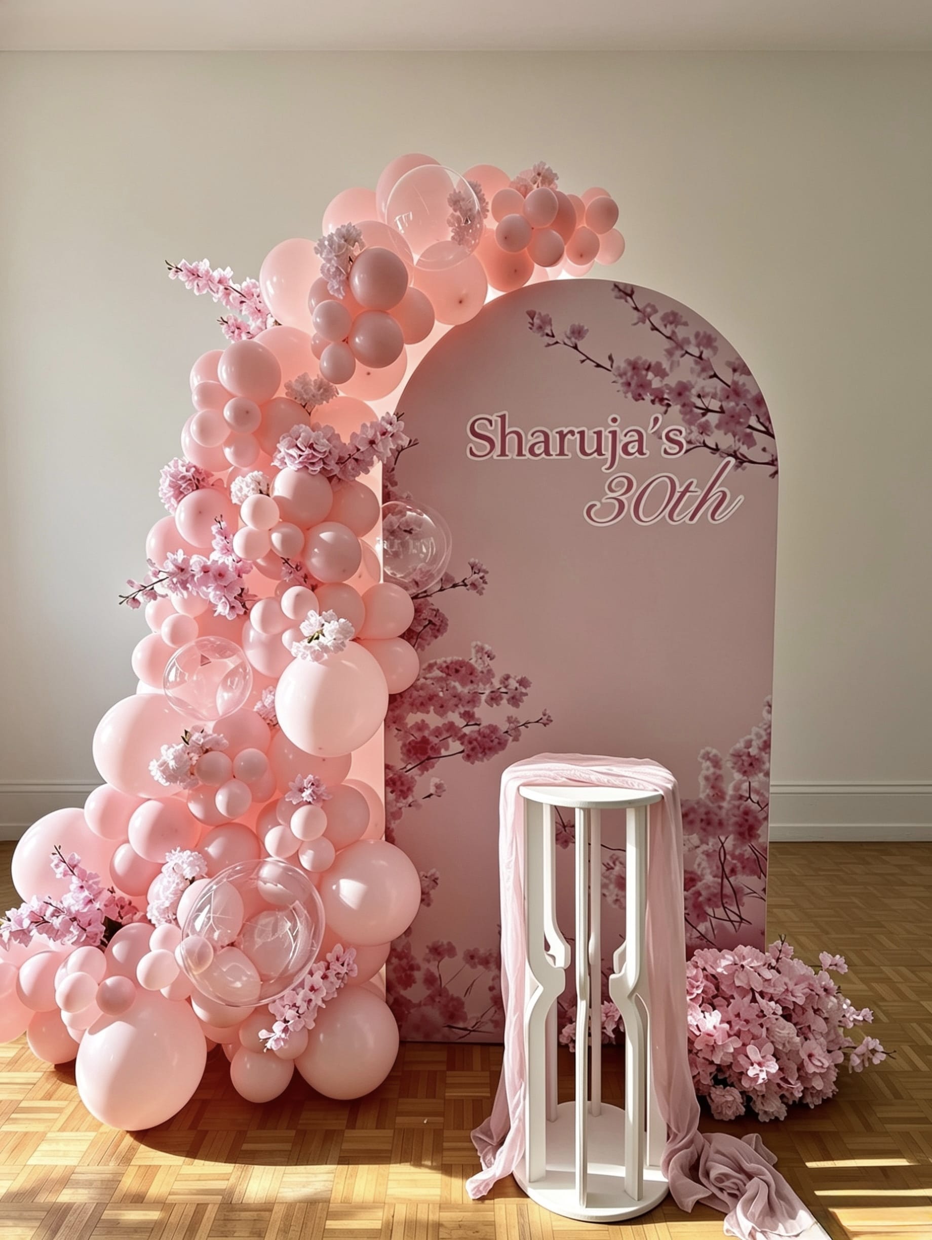 cherry blossom birthday backdrop with pink balloon garland and bubble balloons