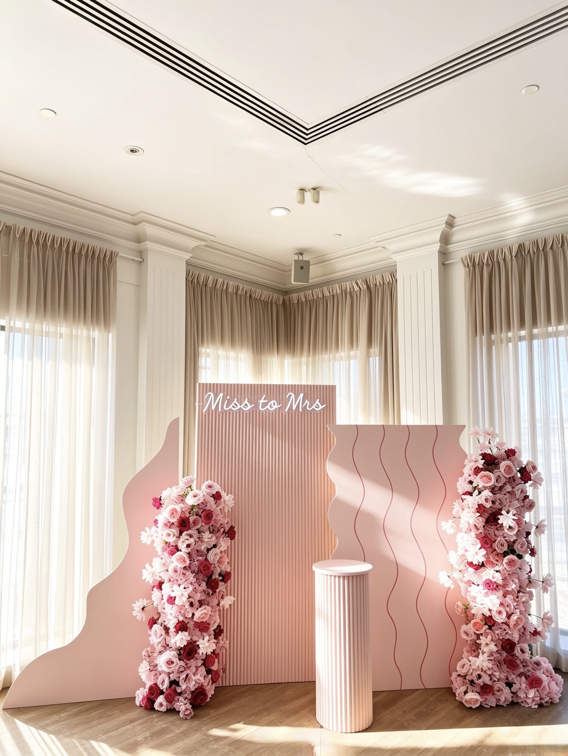 miss to mrs bridal shower backdrop with luxury pink floral arrangements